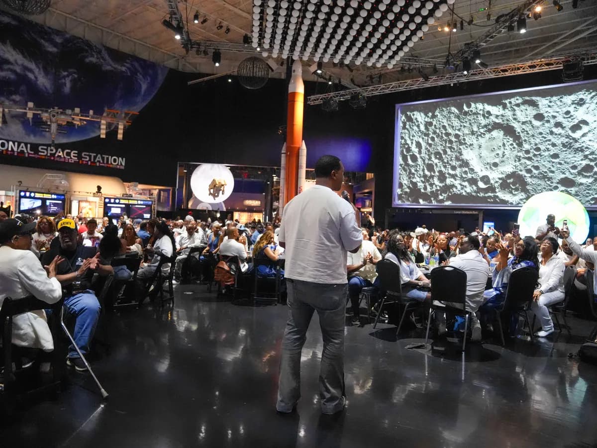 A speaker addressing a crowd in a space-center event hall in Houston
