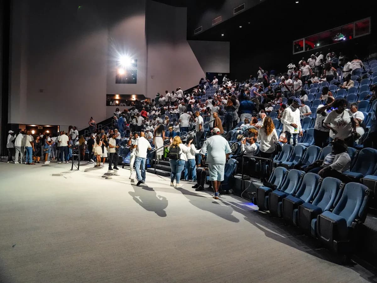 Attendees filling the seats of an auditorium before a training