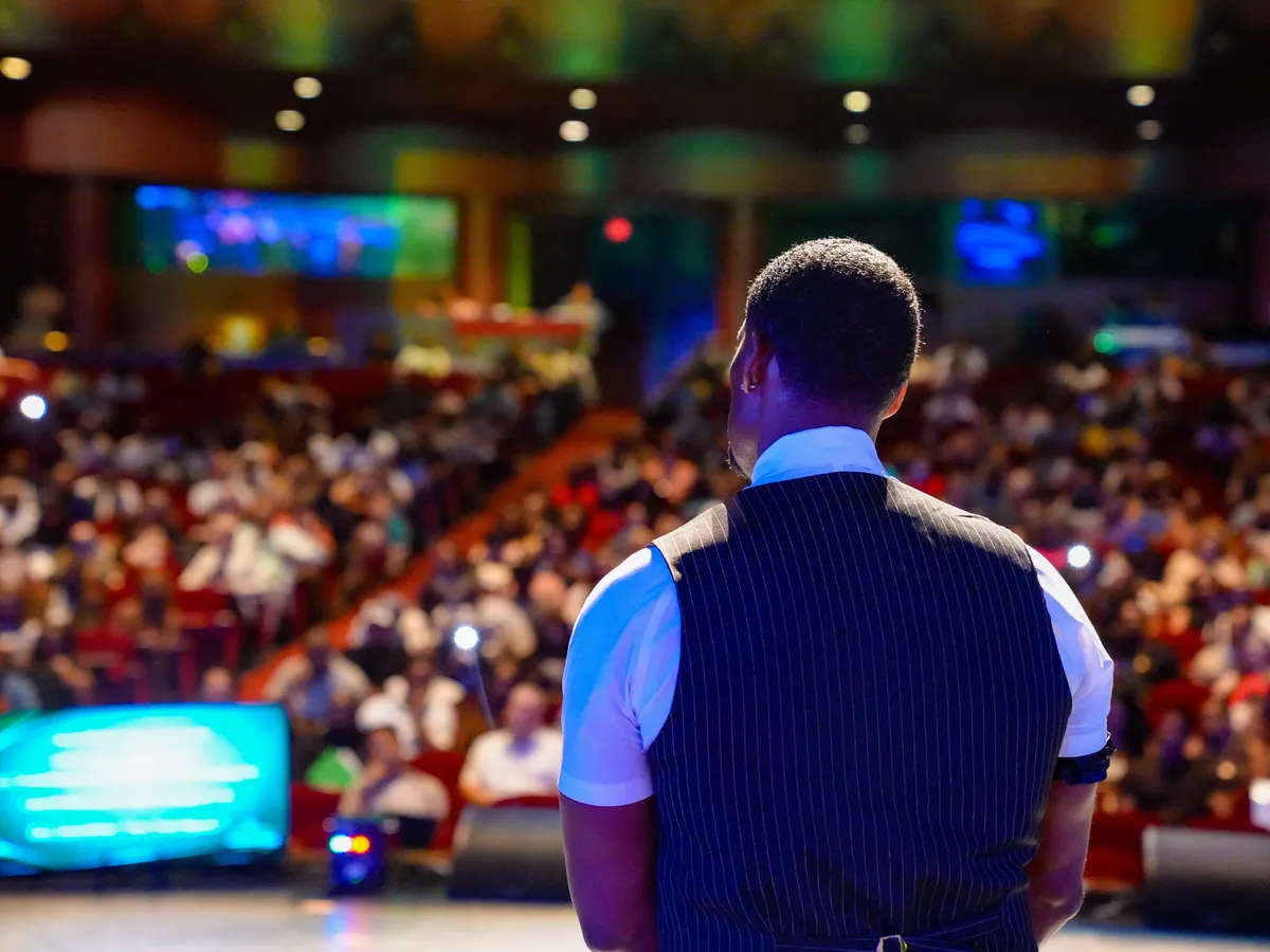 A speaker looking out over the audience from the stage