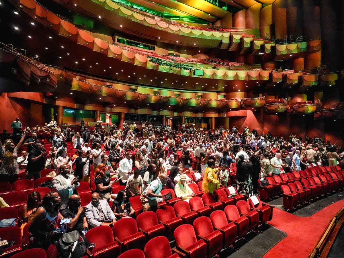 A full theater on its feet at a team event